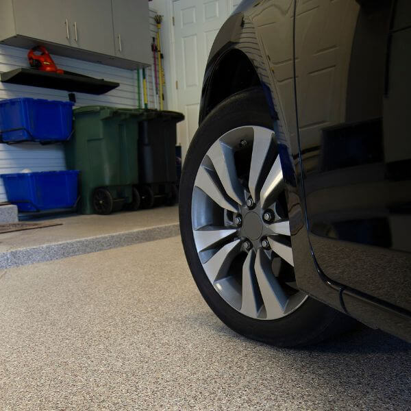 Car parked on flake finish epoxy garage floor by Epoxy Flooring Guys Sydney, showing a clean, non-slip surface for everyday use.