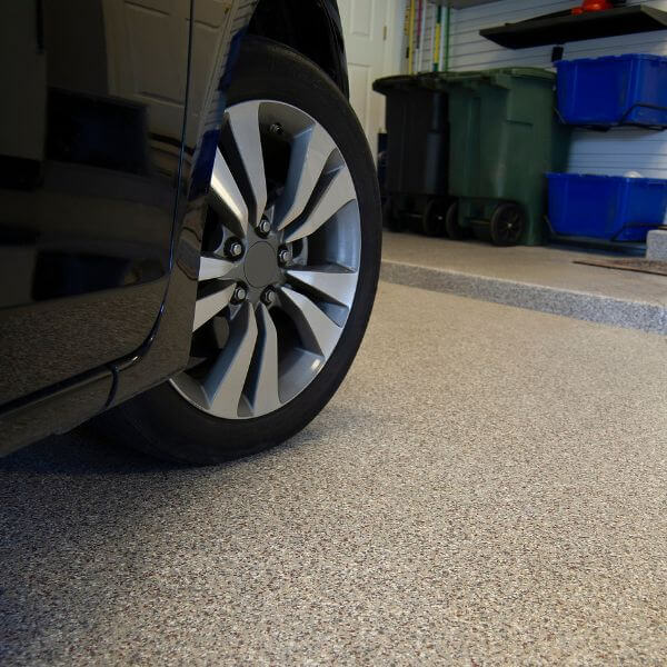 Close-up of epoxy-coated carport floor installed by Epoxy Flooring Guys Sydney. Durable surface built to resist oil stains, tyre marks and daily use.