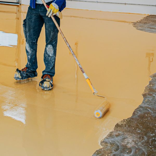 Epoxy Flooring Guys Sydney applying high-build epoxy coating, delivering professional garage and commercial epoxy flooring solutions built to last.