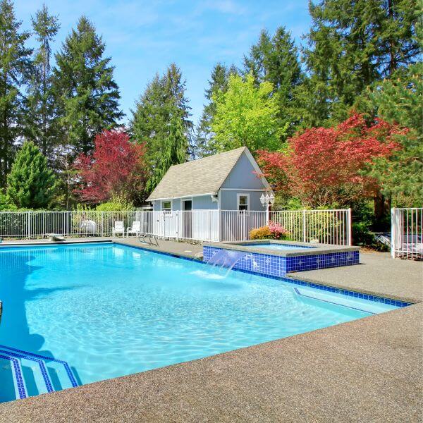 Outdoor swimming pool with slip-resistant epoxy flooring by Epoxy Flooring Guys Sydney. A safe, clean and durable finish designed for splash zones and sunny days.